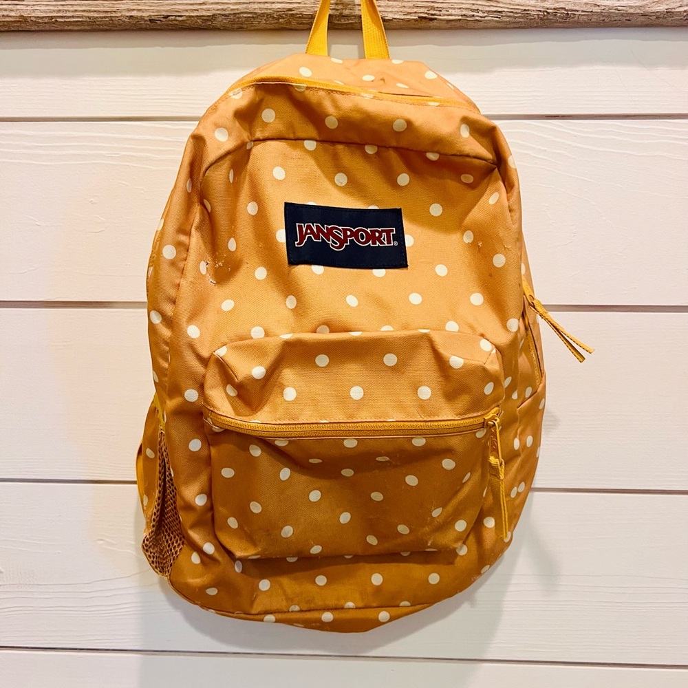 Jansport gold and white polka dot backpack